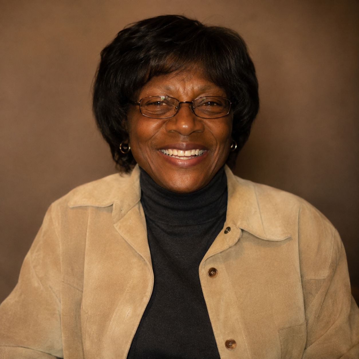 Portrait of CHCC Vice Chair Ms Yvonne Stafford wearing a beige jacket and black turtleneck.