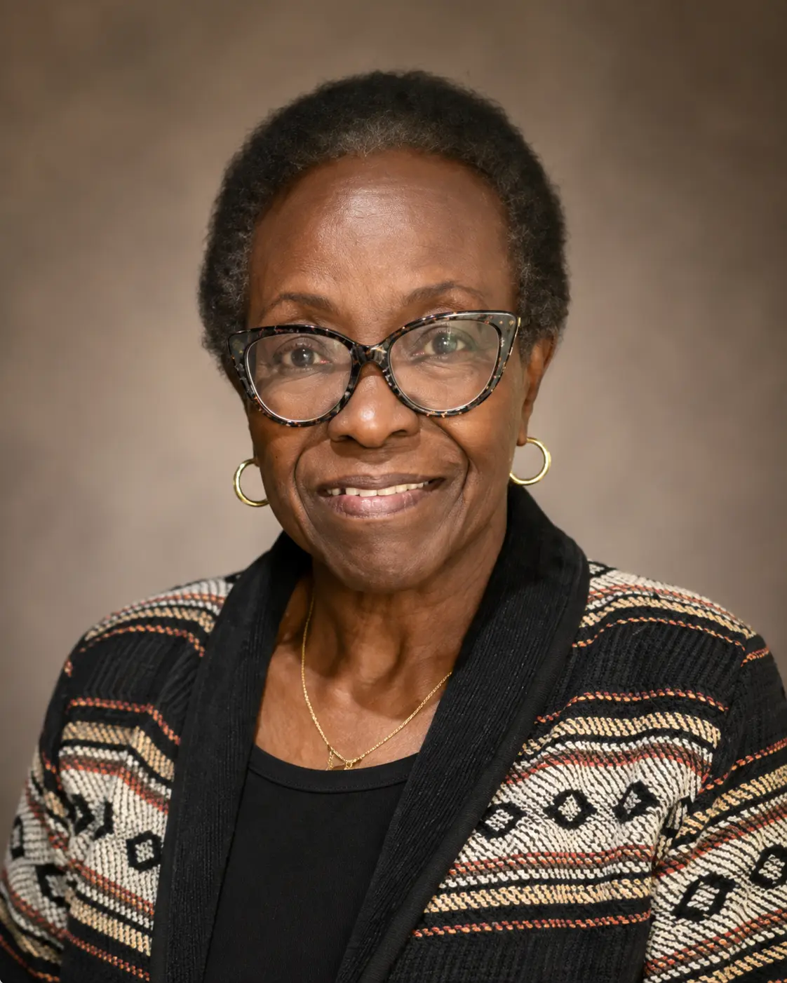 Portrait of a CHCC community leader wearing a patterned cardigan and gold hoop earrings.