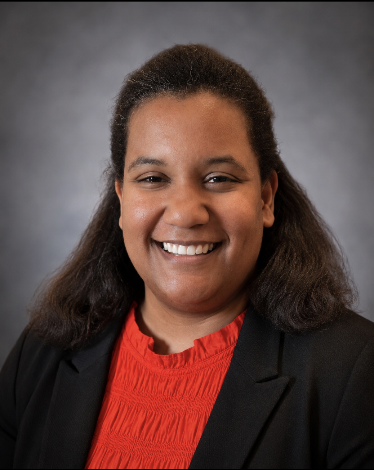 Portrait of CHCC Social Media Advocate M. Martinez wearing a black blazer and red blouse.